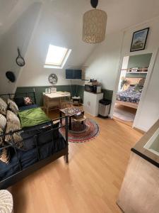 a living room with a couch and a table at Un cocon au Presbytère avec place de parking voiture gratuite in Caen