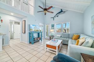 a living room with a couch and a ceiling fan at Paradise Duplex A in Gulf Shores