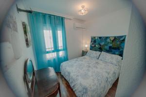 a small bedroom with a bed and a window at Casa Melina in Cala del Moral +22 photos