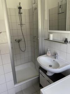 a bathroom with a shower and a sink and a shower at Kamin, Wintergarten & Sonnenterrasse in Wenkendorf auf Fehmarn +20 photos