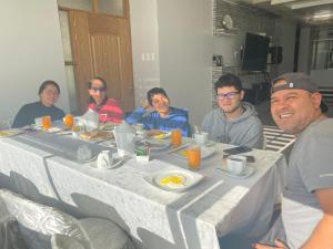 a group of people sitting around a table with eggs at The Royals Huaraz in Huaraz