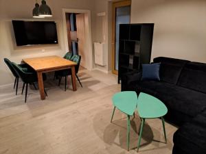 a living room with a couch and a table and chairs at Leśna24c in Rabka-Zdroj