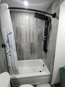a bathroom with a bath tub and a toilet at The Lucky Nook-Comfortable Studio, Close to All in Atlantic City +14 photos
