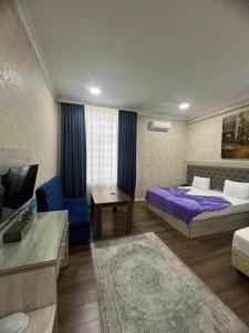 Postel nebo postele na pokoji v ubytování Hotel Empire Business Baku