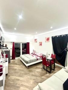 a bedroom with a bed and a table and chairs at Casa Federica in Ventimiglia