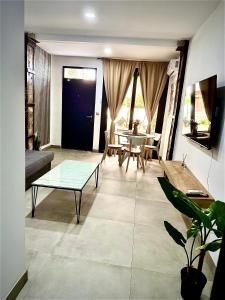 a living room with a table and a couch at Vera Holydays in Torremolinos