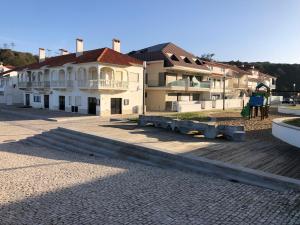 a large building with a wooden deck in front of it at Paredes da Vitória - Surf & Sun in Pataias