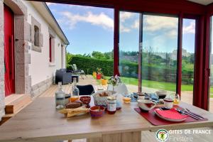 a table with food and drinks on a balcony with a view at Chambre et table d'Hotes Manava Loretta in Bannalec +34 photos
