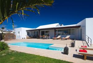a villa with a swimming pool and a house at Villa Perla in Puerto del Carmen