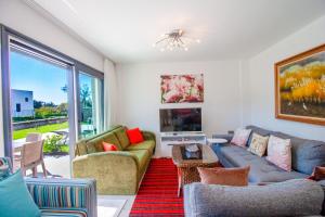 een woonkamer met een bank en een tv bij Villa Casa Luz 2 in Bodrum City