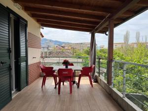 a patio with a table and chairs on a balcony at Raffaello's Villa in Vlorë