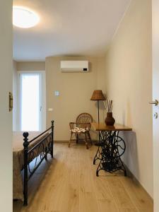 a bedroom with a bed and a table with a lamp at Ca' dal Pum - Lake Orta - Elegant holiday home in Gozzano