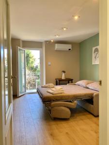 a bedroom with a large bed and a window at Ca' dal Pum - Lake Orta - Elegant holiday home in Gozzano +12 photos