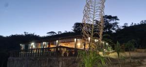 a house with lights in front of it at Chale do guerreiro in Coroas