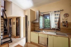 a kitchen with a sink and a window at Sani Villa Suave with pool in Sani Beach +35 photos