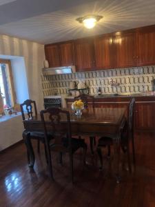 a kitchen with a wooden table with chairs and a tableasteryasteryasteryasteryastery at Cleopatrahouse in Stemnitsa +22 photos