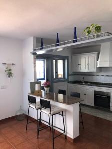 a kitchen with a table and chairs in a room at Casa Chacho, Punta Mujeres in Punta de Mujeres
