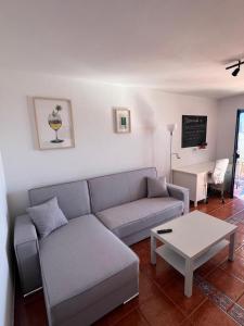 a living room with a couch and a coffee table at Casa Chacho, Punta Mujeres in Punta de Mujeres