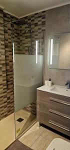 a bathroom with a sink and a shower and a sink at Los Cristianos Penthouse in Arona +20 photos
