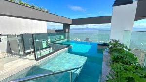 an image of a swimming pool in a house at Estadia tranquila e completa em prédio com piscina – VPD in Florianópolis