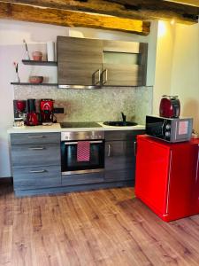a kitchen with a stove and a red refrigerator at Maiberg in Heppenheim an der Bergstrasse