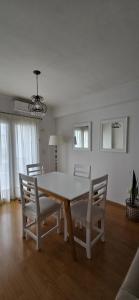 a dining room with a table and chairs at Departamento Paz in Tandil
