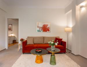 a living room with a red couch and a table at Mia Homes - Acropolis in Athens