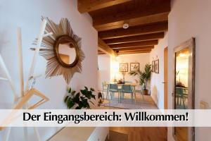 a living room with a mirror and a table at Helle 72qm Maisonette Wohnung im Herzen Erfurts mit Kingsize Bett, Smart-TV, etc in Erfurt