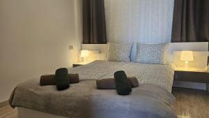 a bedroom with a large bed with two pillows at Los Cristianos Penthouse in Arona