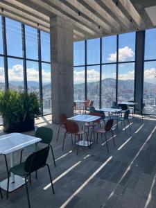 a room with tables and chairs and windows at B&B KELLY Ecuador in Quito +15 photos