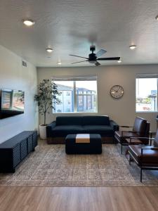 a living room with a black couch and chairs at Sonoro Sands in Hurricane