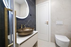 a bathroom with a bowl sink on a counter at Platea Magna Lux Apartment in Zadar +45 photos