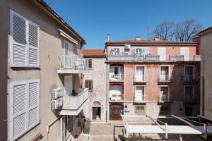 an apartment building with balconies and people on a balcony at Platea Magna Lux Apartment in Zadar