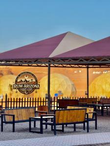 a group of benches sitting in front of a building at RUM ARIZONA lUXURY CAMP in Wadi Rum