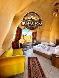 a room with a bed and a sign that reads run africanvana at RUM ARIZONA lUXURY CAMP in Wadi Rum +33 photos
