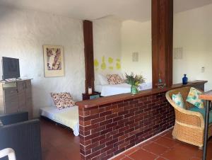 a room with two beds and a brick wall at La Casona Llanera in San Martín