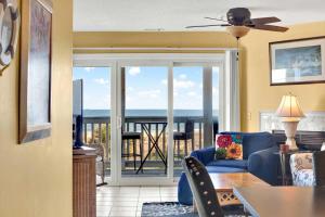 a living room with a view of the ocean at Ocean front condo Sandcastles beach club in Tybee Island