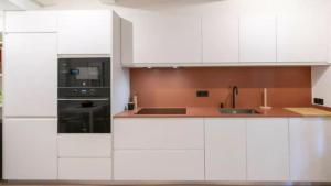a white kitchen with white cabinets and a sink at Apartamento Balears Navarra Ibiza in Ibiza Town