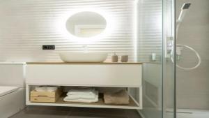 a bathroom with a sink and a glass shower at Apartamento Balears Navarra Ibiza in Ibiza Town