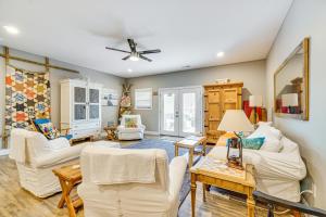 a living room with white furniture and a ceiling fan at Lakefront Boating Getaway in Spring City! in Spring City