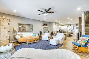 a living room with white furniture and a ceiling fan at Lakefront Boating Getaway in Spring City! in Spring City