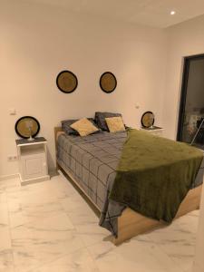 a bedroom with a bed with two mirrors on the wall at Apartamento Praia JOIA in Praia +8 photos