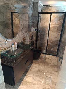 a bathroom with two sinks and a shower at Apartamento Praia JOIA in Praia