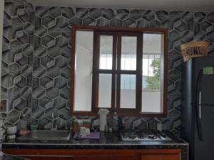 a kitchen with a sink and a window in it at Apartaestudio 405 in Acacías +3 photos