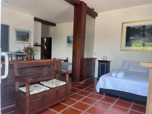 a bedroom with a bed and a table in it at La Casona Llanera in San Martín
