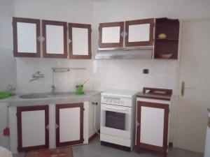 a kitchen with a white stove and a sink at La Corte del Gavi in Bosio +5 photos