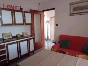 a living room with a red couch and a red chair at La Corte del Gavi in Bosio