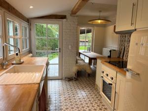 a kitchen with a dog looking out the window at Tilia in Damme