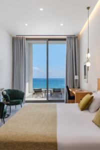 a bedroom with a bed and a view of the ocean at Mythical Coast Wellness Retreat in Mytilini