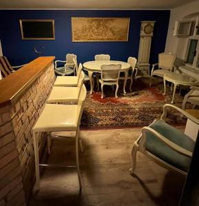 a dining room with tables and chairs and a wall at Hostel One in Bratislava